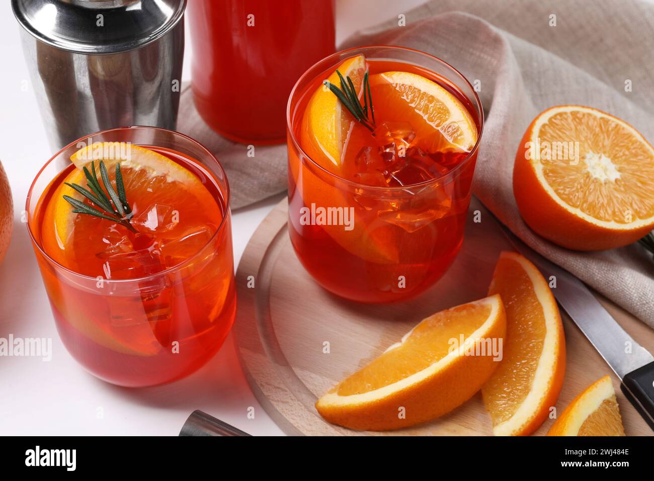 Aperol spritz cocktail, rosemary and orange slices on white wooden ...