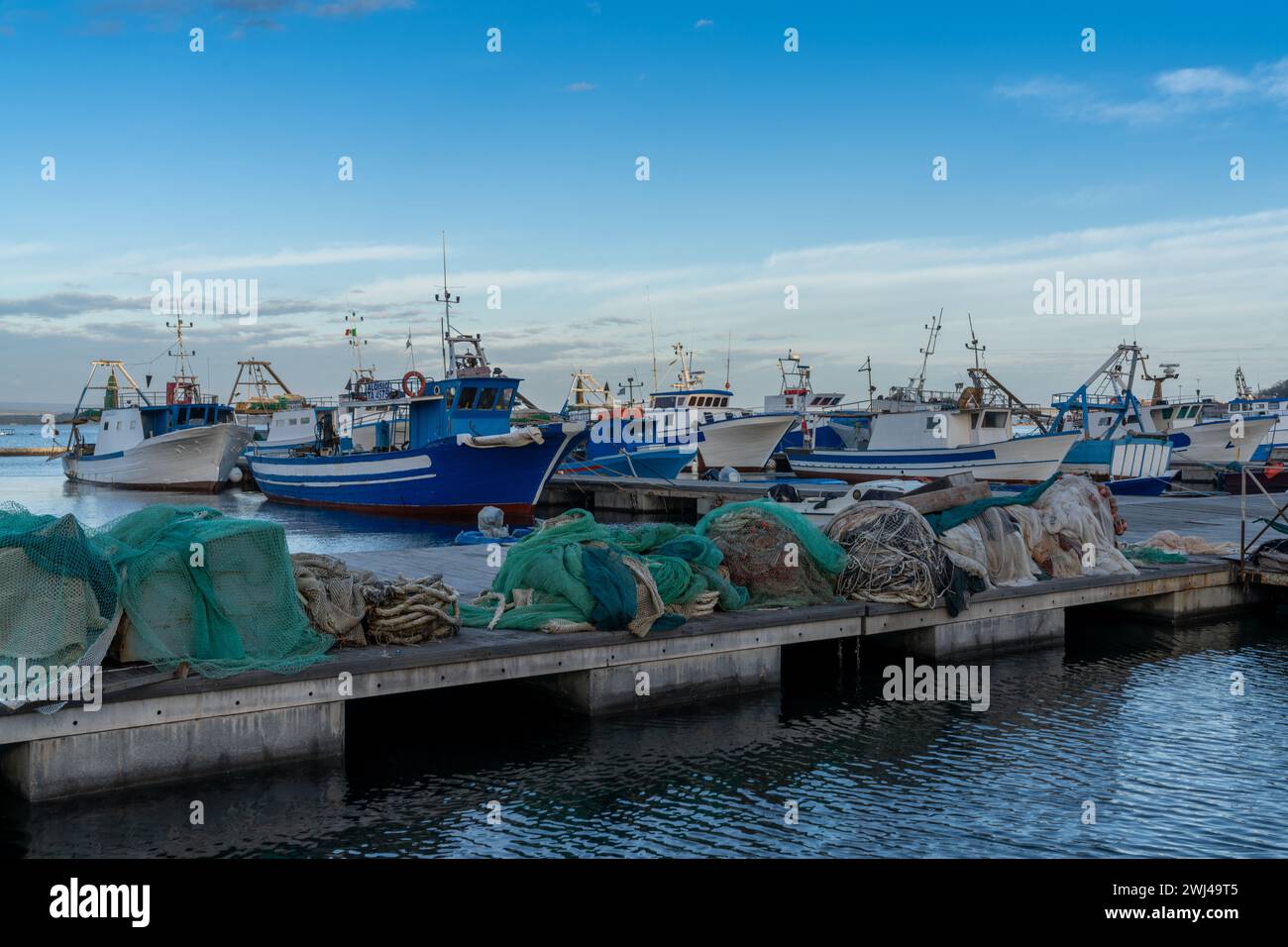 Fishing boats and docks in the commercial harbour of Taranto Stock Photo