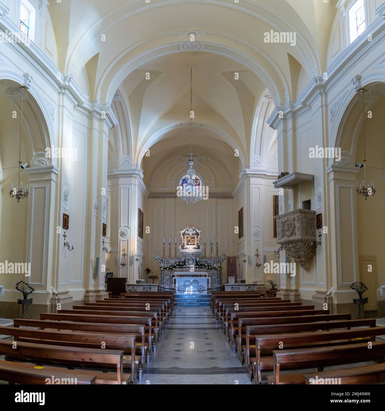 Interior view of the central nave and altar of the Cristo Re Church in Santa Maria di Leuca Stock Photo