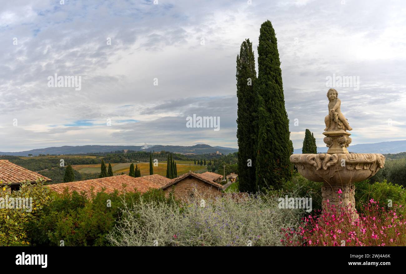 View of the guest houses and gardens of the Villa Banfi with Tuscan landscape behind Stock Photo