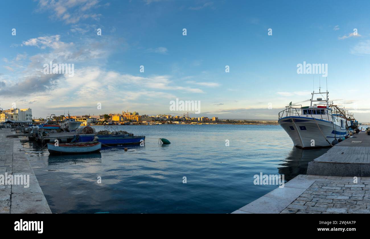 Fishing boats and docks in the commercial harbour of Taranto Stock Photo