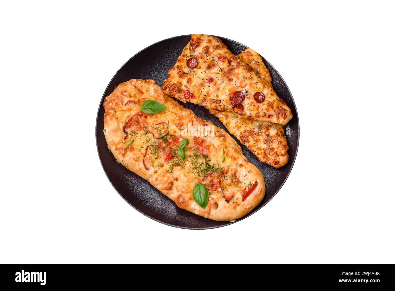 Delicious oven fresh flatbread pizza with cheese, tomatoes, sausage, salt and spices Stock Photo