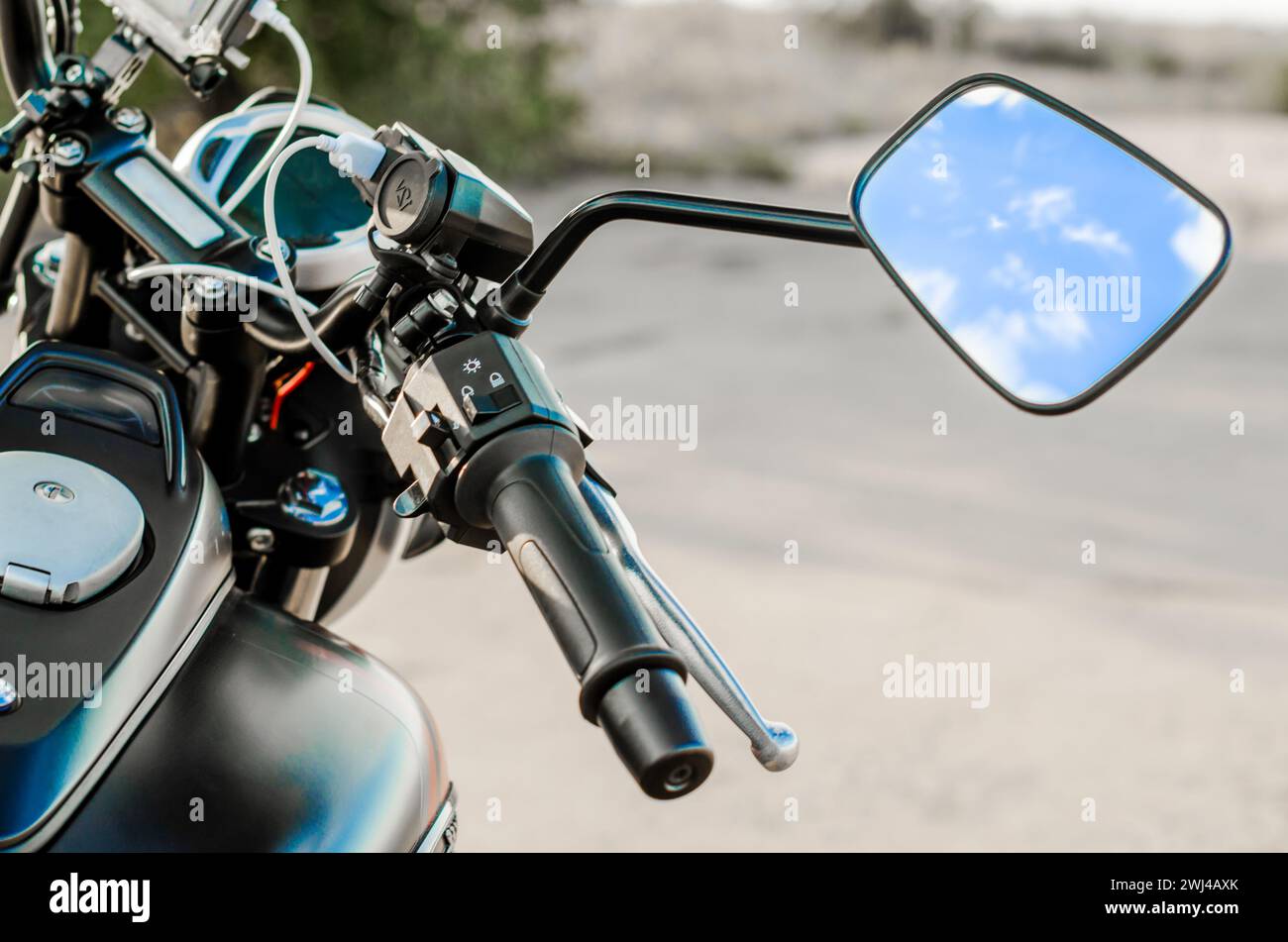 Reflection of the nab and clouds in the motorcycle mirror, motorcycle steering wheel and motorcycle fuel tank Stock Photo