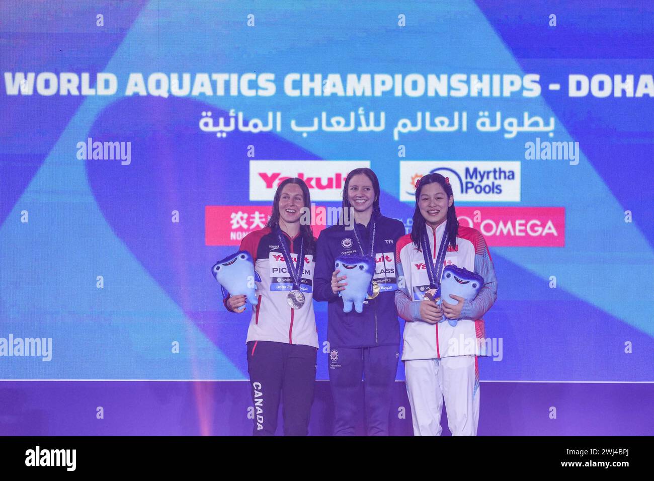 Doha, Qatar. 12th Feb, 2024. Gold medalist Kate Douglass(C) of the United States, Silver medalist Sydney Pickrem (L) of Canada, bronze medalist Yu Yiting of China pose for photos during the awarding ceremony of the women's 200m individual medley final of swimming event at the World Aquatics Championships 2024 in Doha, Qatar, Feb. 12, 2024. Credit: Du Yu/Xinhua/Alamy Live News Stock Photo