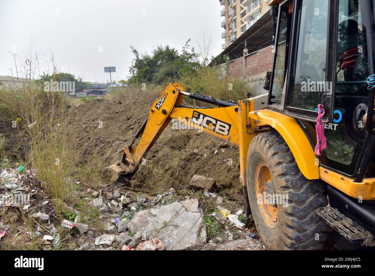 India. 11th Feb, 2024. GHAZIABAD, INDIA - FEBRUARY 12: JCB machine digging potholes on the side of the road before the arrival of farmers tomorrow at Delhi Ghazipur border on February 12, 2024 in Ghaziabad, India. Farmers from across multiple states bordering the country capital are set to launch their ‘Chalo Delhi' march on February 13, putting forth their list demands for the central government to take in account. (Photo by Sakib Ali/Hindustan Times/Sipa USA) Credit: Sipa USA/Alamy Live News Stock Photo