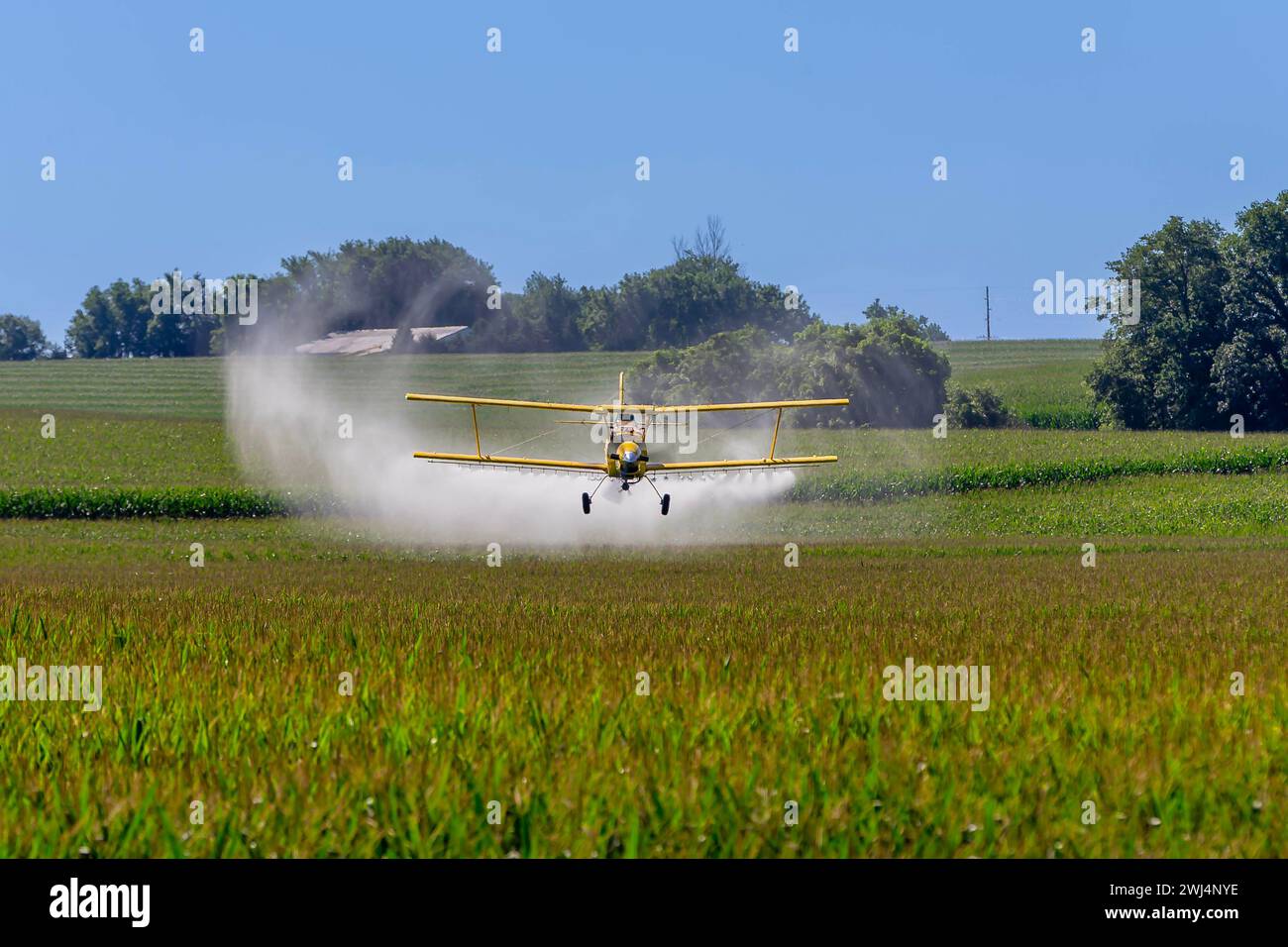 Lowflying crop duster combats pests, safeguarding fields with