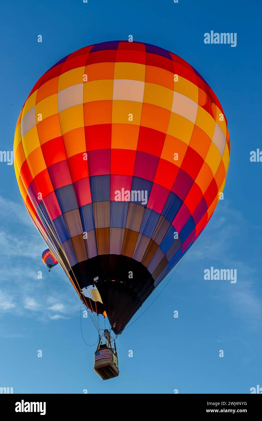 Spectacular Sky Ballet: Dazzling Balloons Paint the Blue Canvas with Joyful Colors Stock Photo
