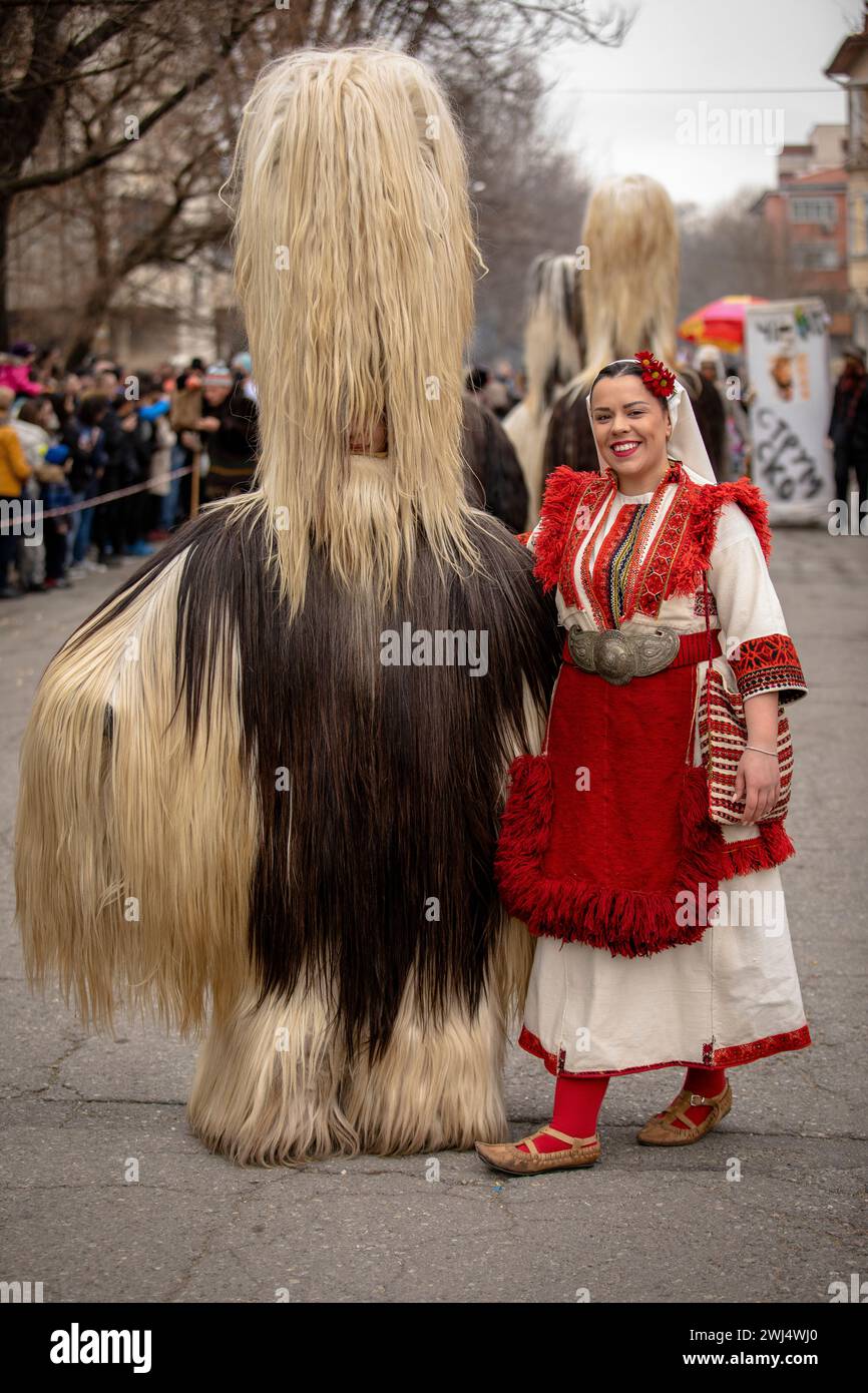 Kyustendil, Bulgaria - February 10, 2024: First edition of masquerade festival in Kyustendil Bulgaria. Men and women dressed in Bulgarian folk kuker c Stock Photo