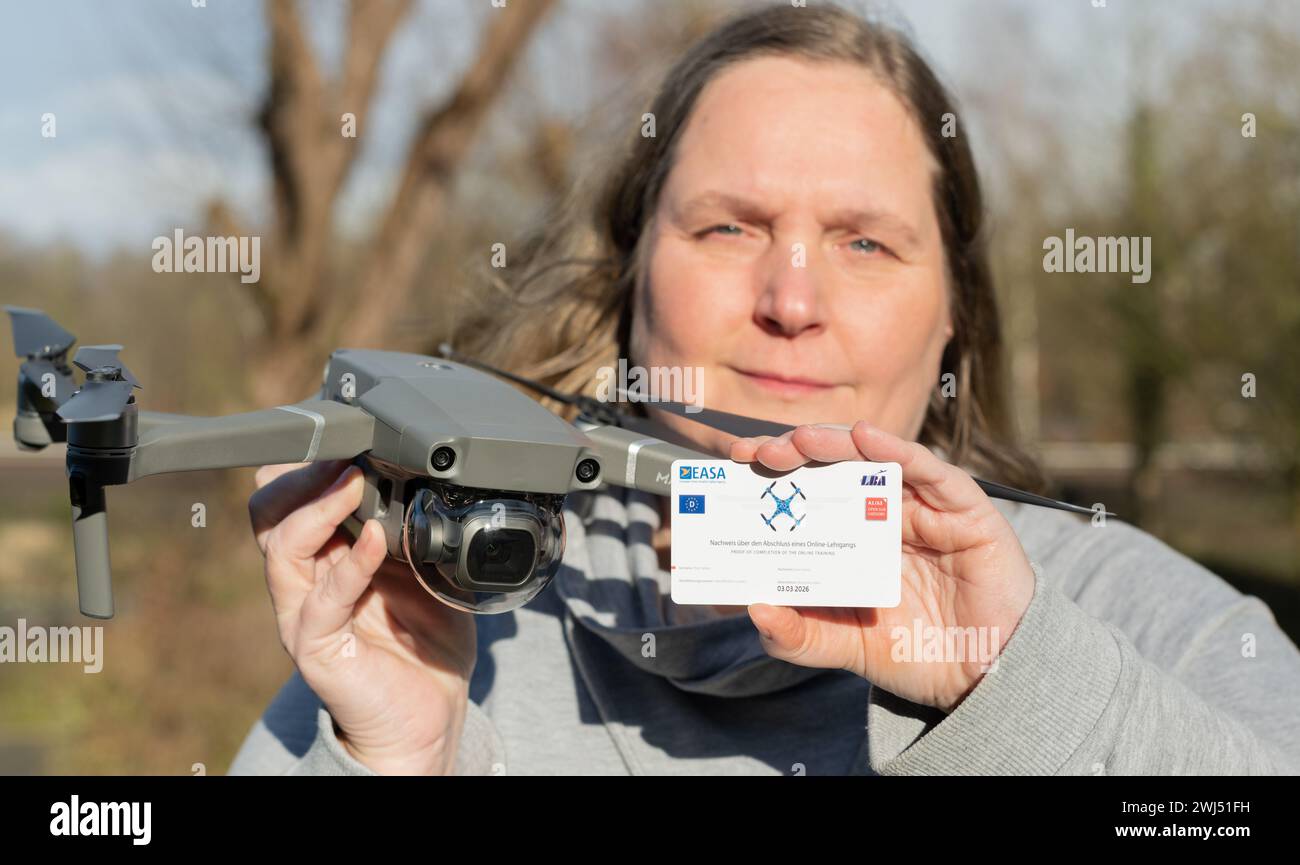 The woman has successfully obtained the drone pilot's license while holding a DJI Mavic Pro 2 drone Stock Photo