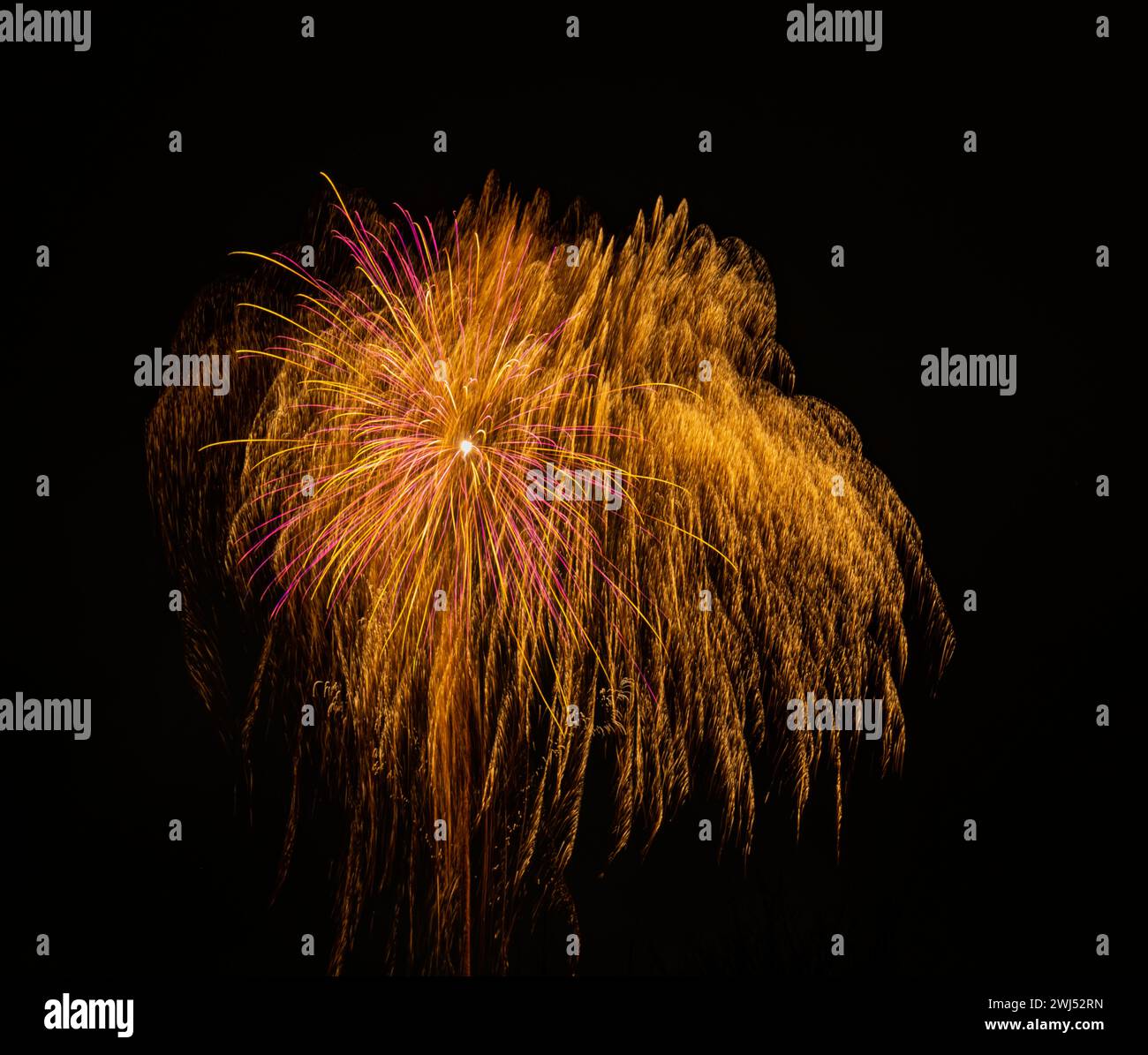 Long exposure abstract sparks from a New Year's Eve fireworks for backgrounds Stock Photo