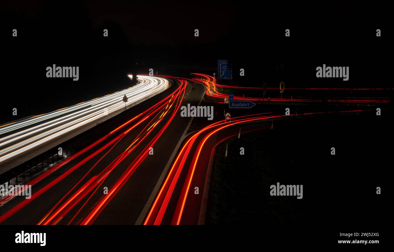 Long exposure, white front and red rear lights as car light strips at night Stock Photo