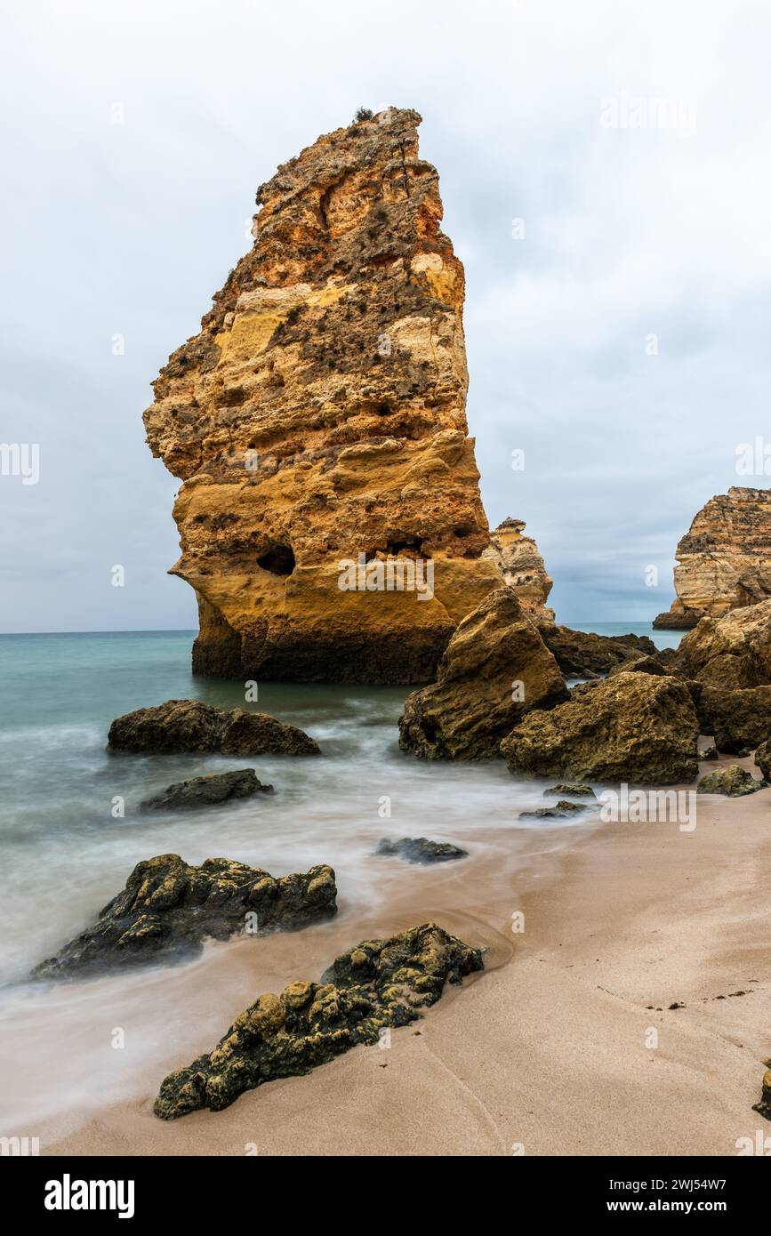 Rocky cliffs on sandy Marinha Beach in Algarve coast at Atlantic Ocean in Portugal Stock Photo