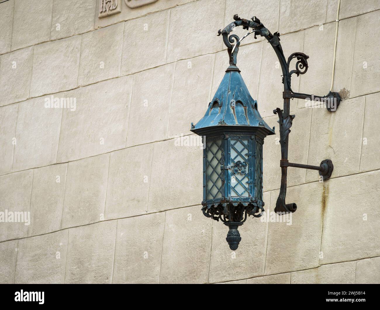 Antique lantern on a stone wall Stock Photo
