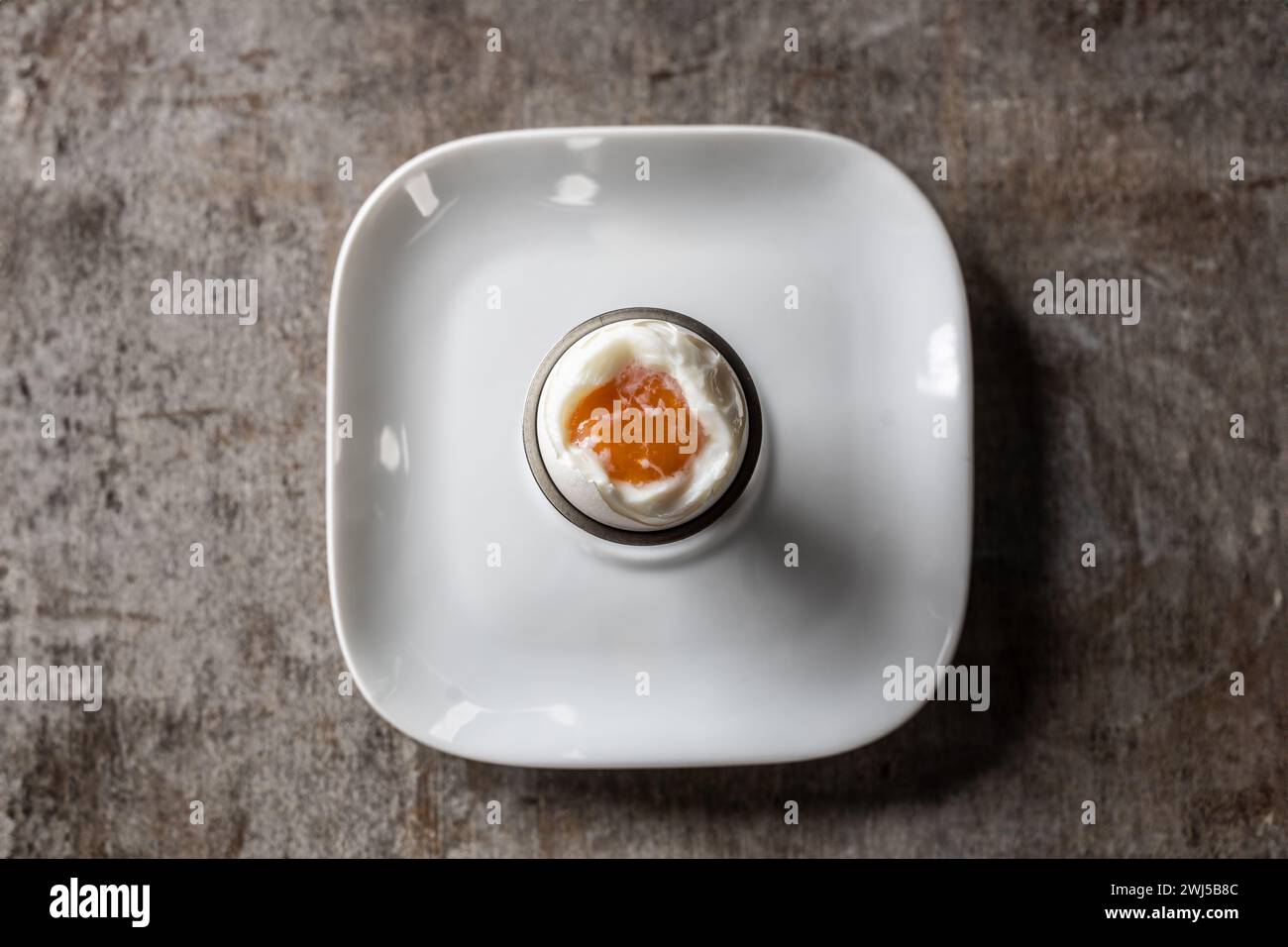 Soft-boiled egg in eggcup - top of view. Stock Photo