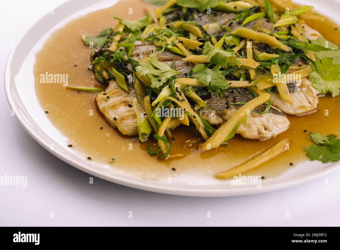 Fried fish fillet. cod with sauce and herbs Stock Photo