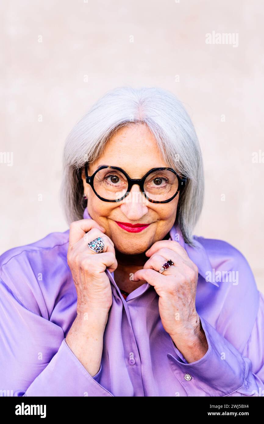 nice senior woman in glasses smiling looking at camera Stock Photo