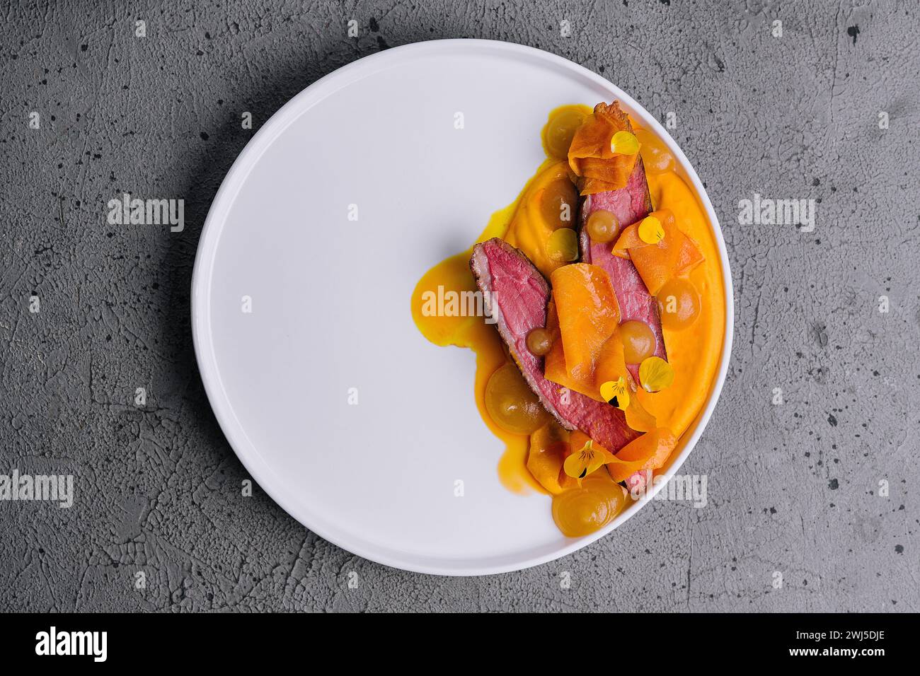 Exquisite serving juicy duck tenderloin with carrot puree Stock Photo