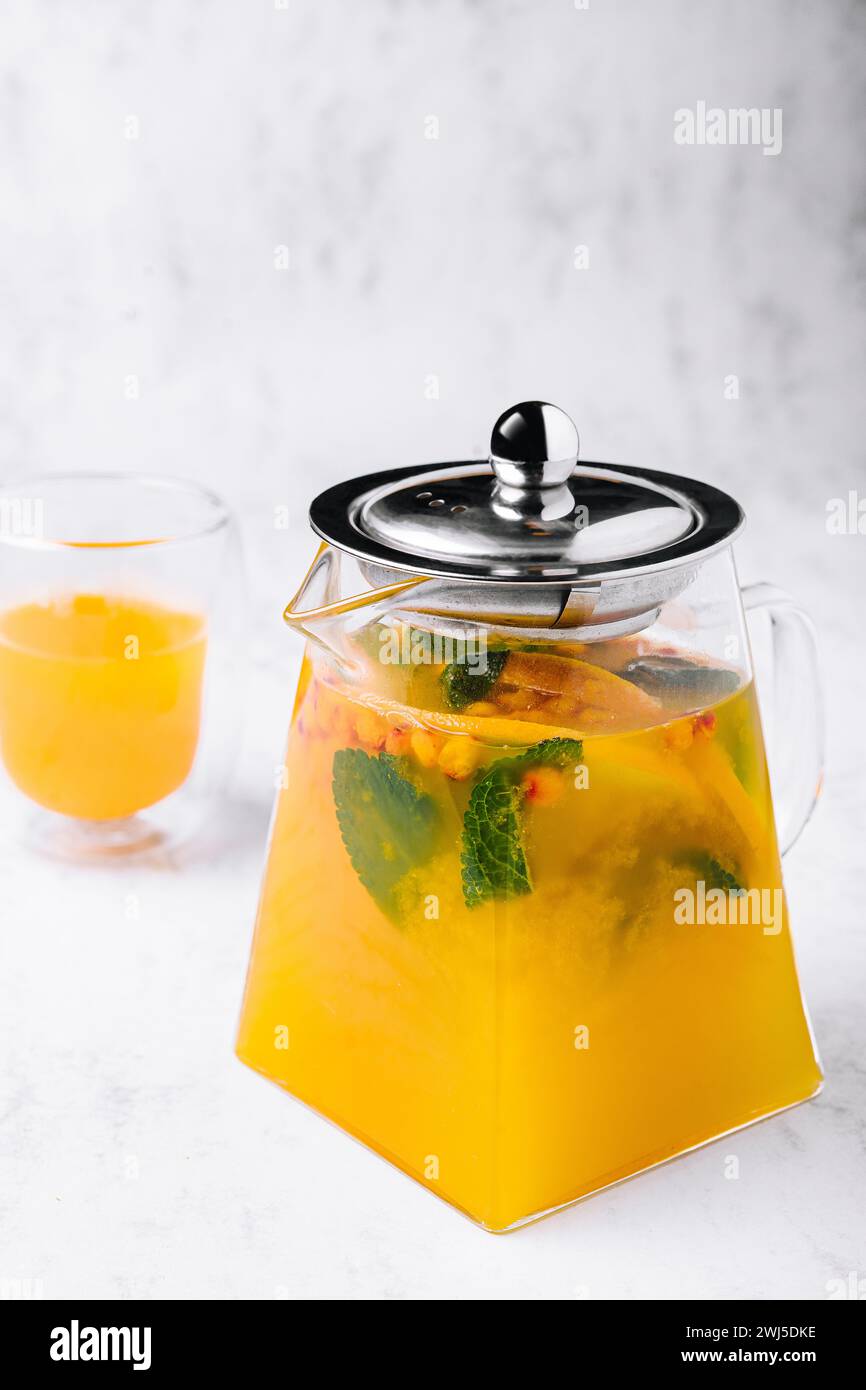 Tea with mint and orange. aromatic hot drink in glass jar. Stock Photo