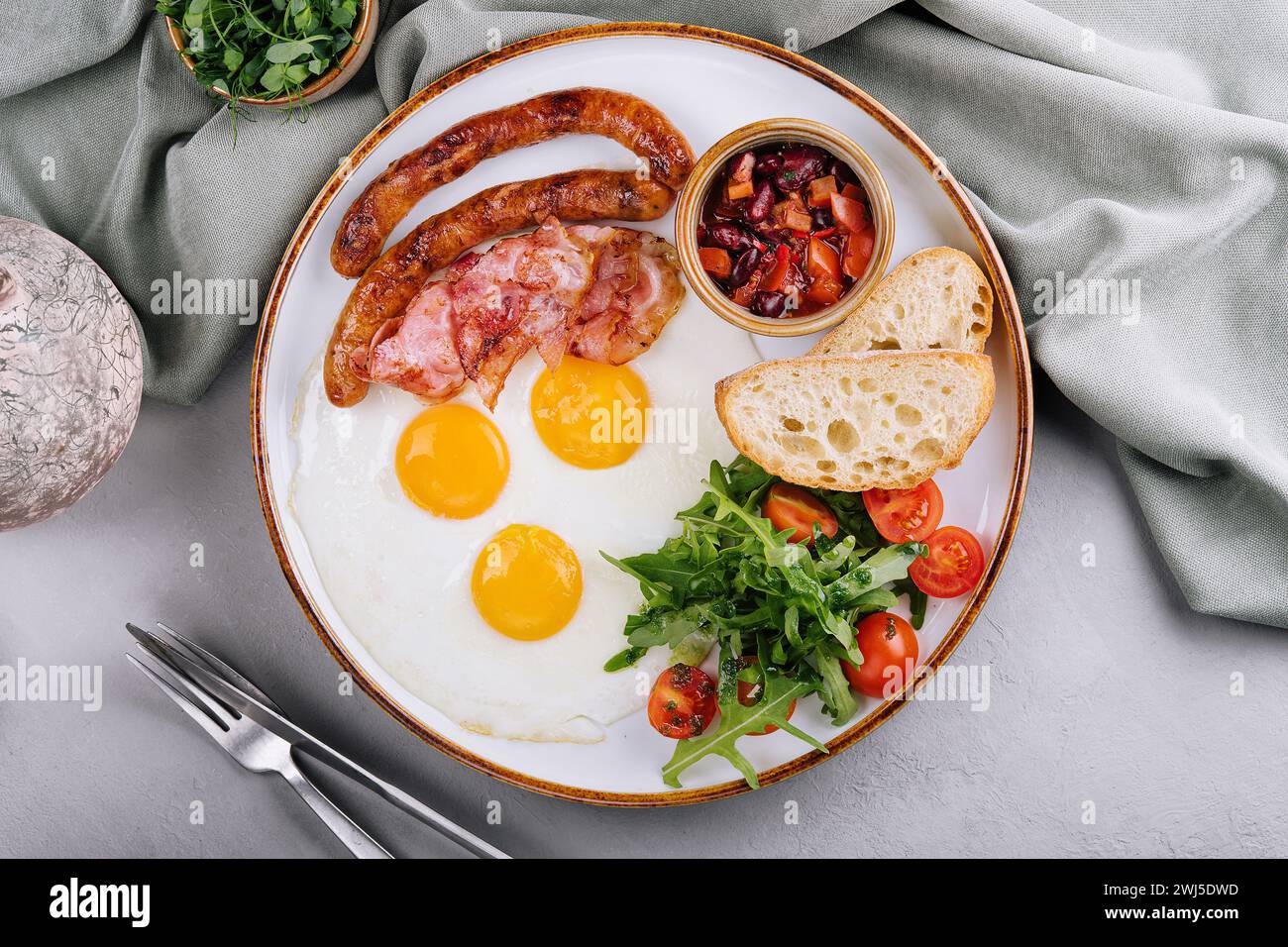 Fried eggs and bacon for breakfast on a plate Stock Photo - Alamy