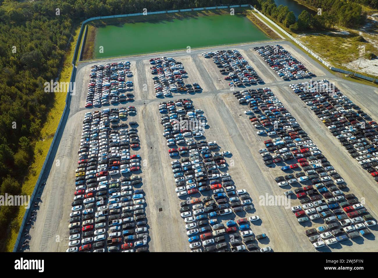 Aerial view of auction reseller company big parking lot with parked cars ready for remarketing services. Sales of secondhand vehicles Stock Photo