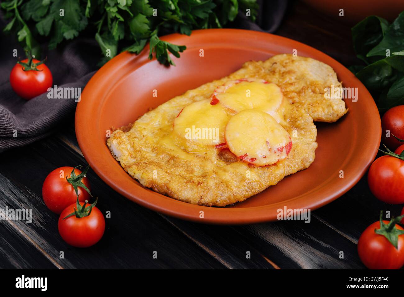 Chicken fillet baked in the oven with cheese and tomatoes Stock Photo ...