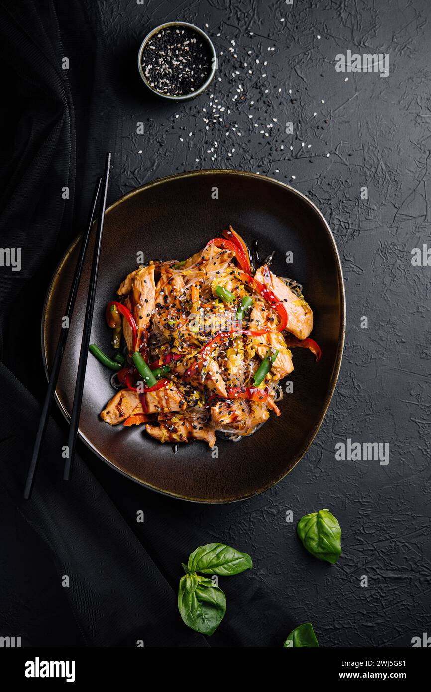 Asian udon noodles with chicken vegetables and teriyaki sauce Stock Photo
