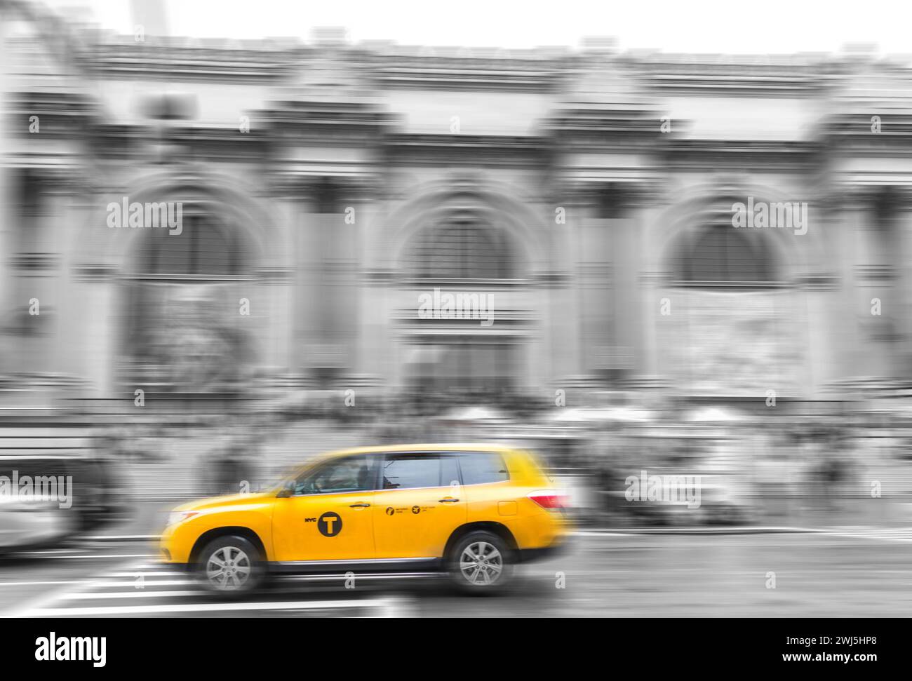 Yellow taxi Cab at The Metropolitan museum in New York City in black and white toning with motion blur effect Stock Photo