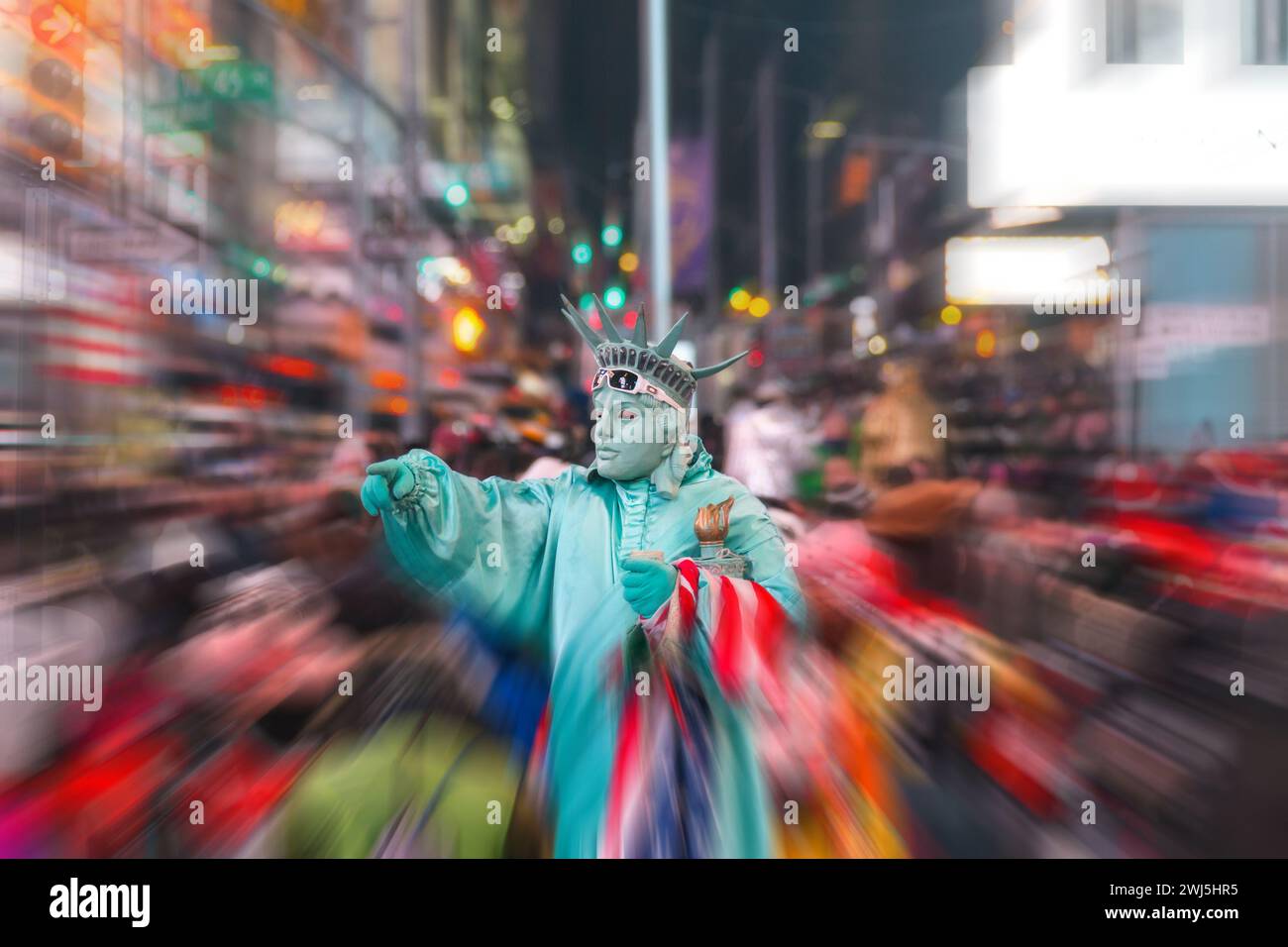 Night view of the Times Square street with street artists and huge crowd with motion blur effect Stock Photo