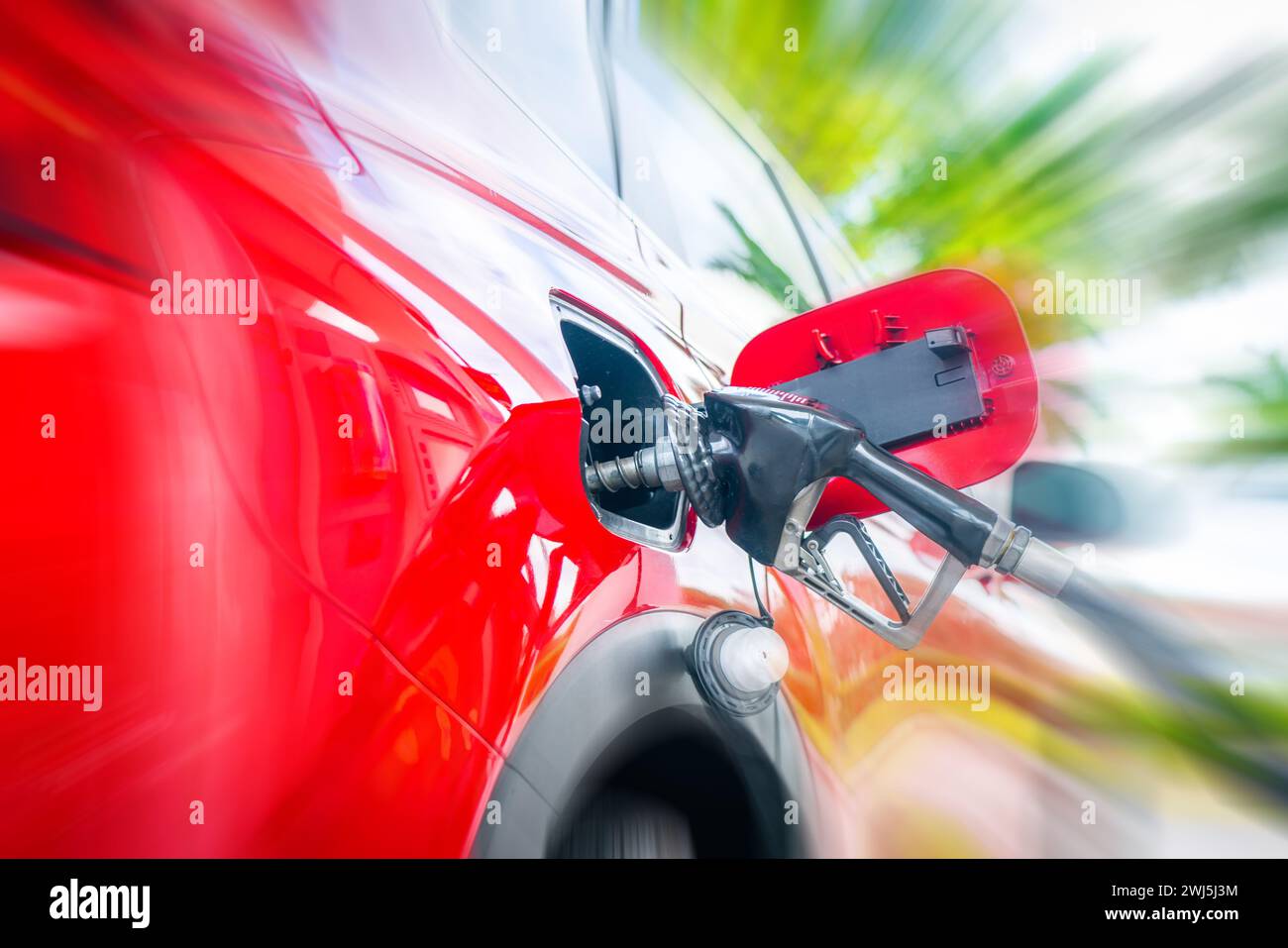 Car refueling on petrol station. Fuel pump with gasoline. Service is filling gas or diesel into tank with motion blur effect Stock Photo