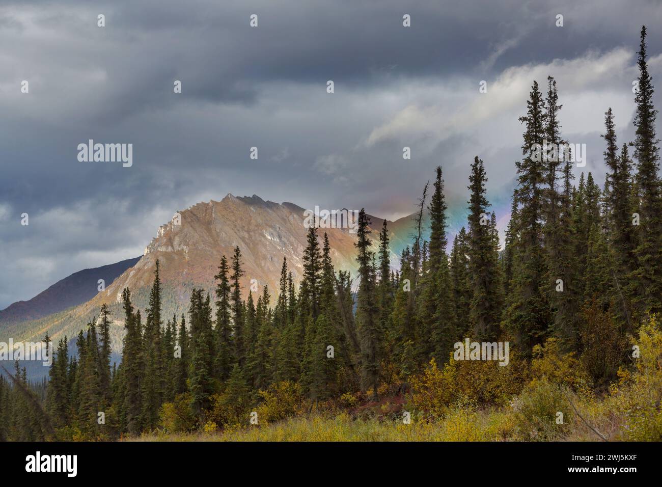 Rainbow in mountains Stock Photo