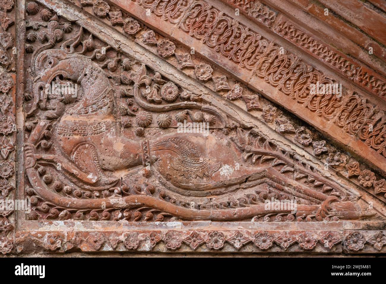 Closeup view of carved terracotta mythological horselike creature on exterior wall of ancient Chota Anhik hindu temple, Puthia, Rajshahi, Bangladesh Stock Photo