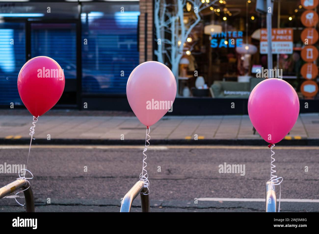 Kingston-Upon-Thames, London UK, February 12 2024, Pink Balloons Tied To Roadside Bicycle Stands With No People Stock Photo