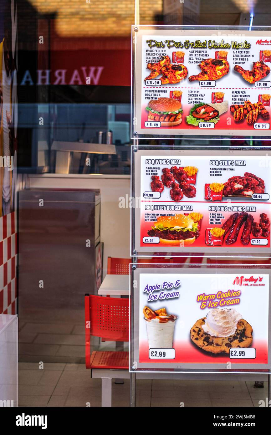 Kingston-Upon-Thames, London UK, February 12 2024, Food Menu In Window Of A Chicken and BBQ Fast Food Shop With No People Stock Photo