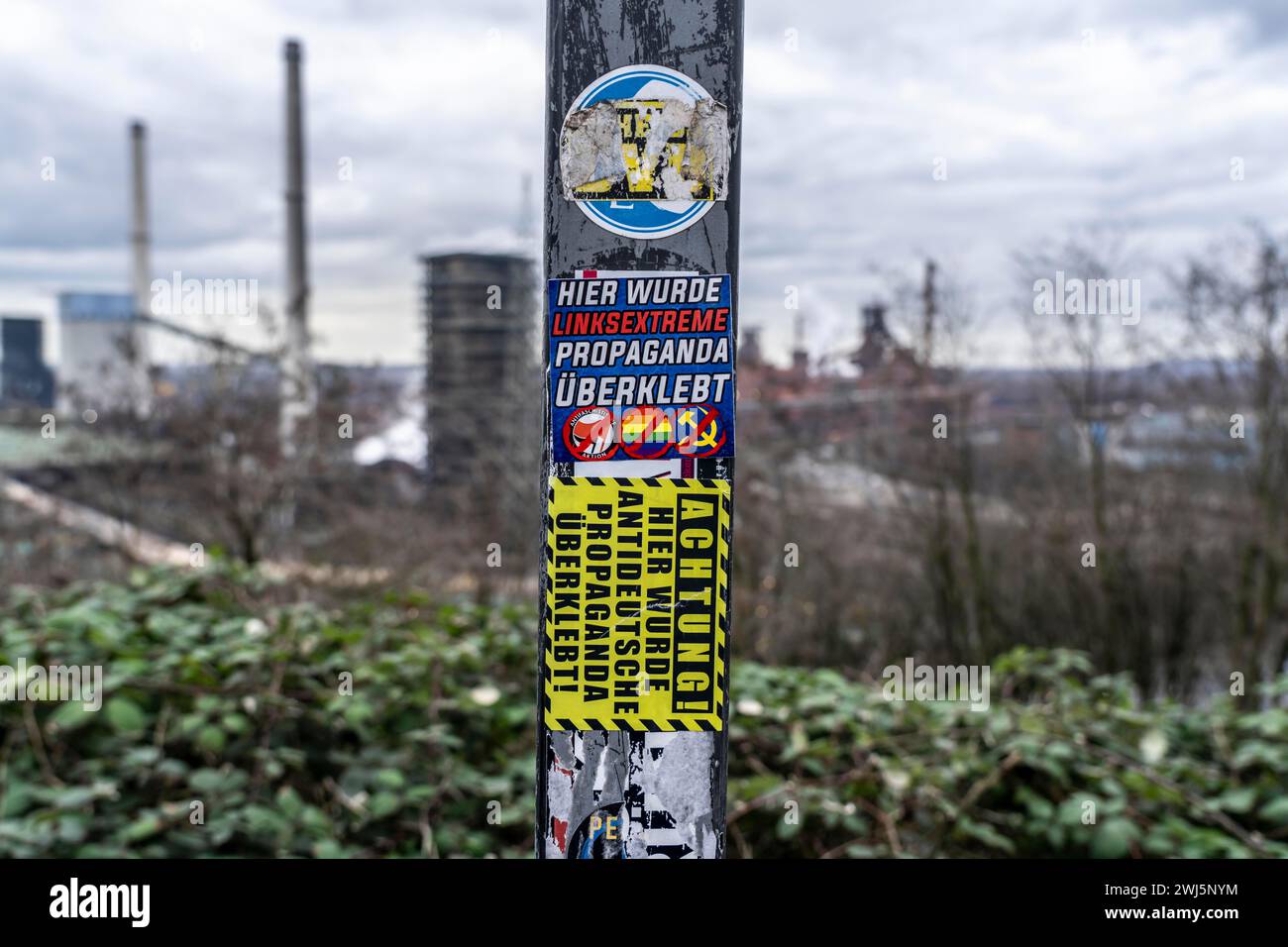 Stickers of right-wing extremist groups pasted over stickers of apparently left-wing groups, Duisburg, NRW, Germany, Stock Photo