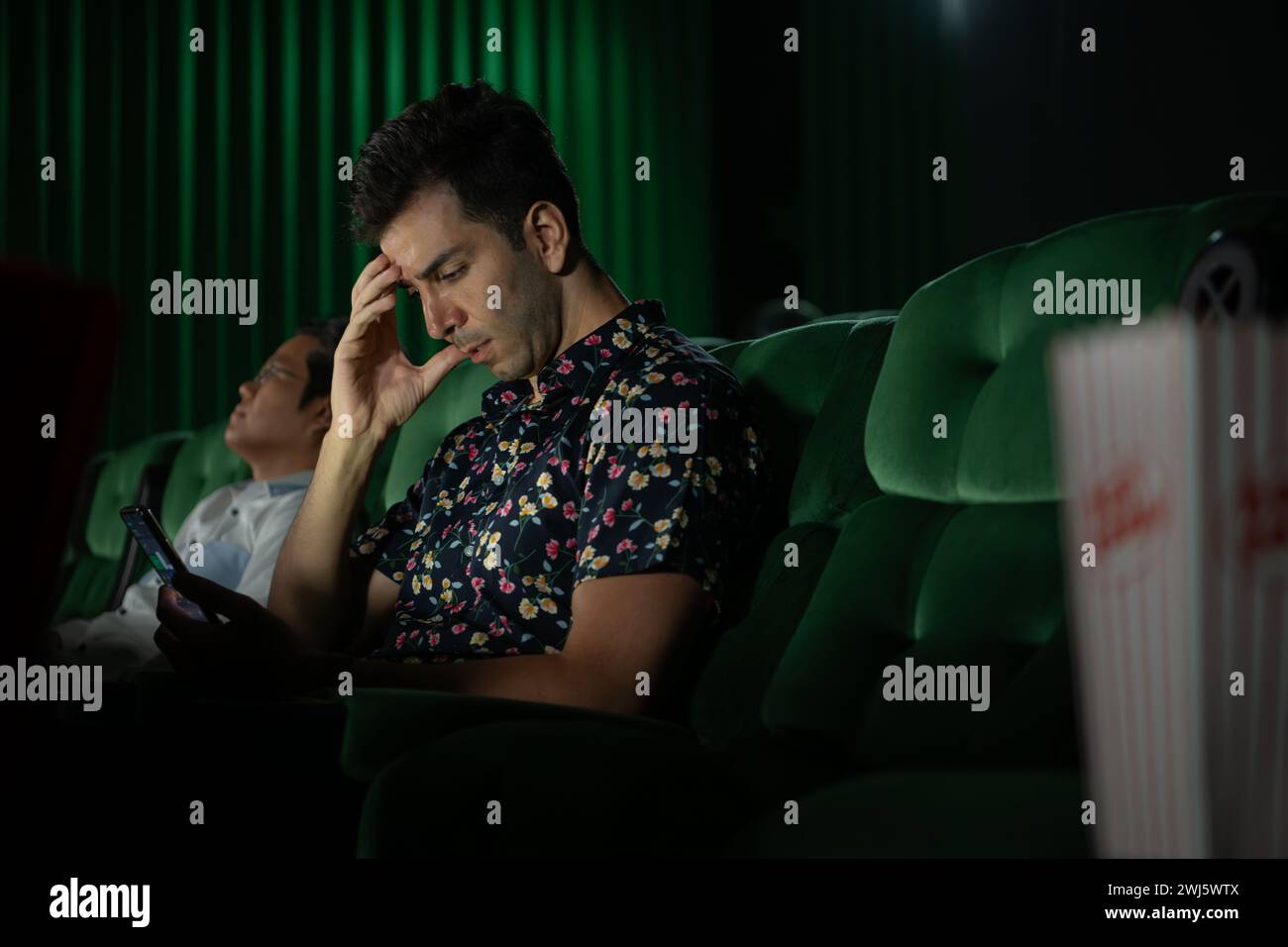 Cinema concept. People watching movie at cinema eating popcorn Stock Photo