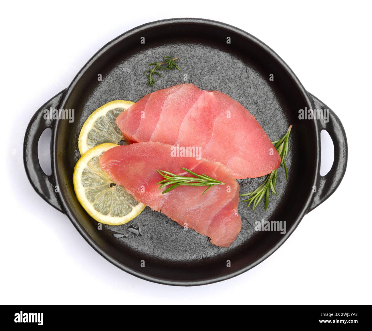 Fresh tuna Fish steak in black ceramic dish isolated on a white ...