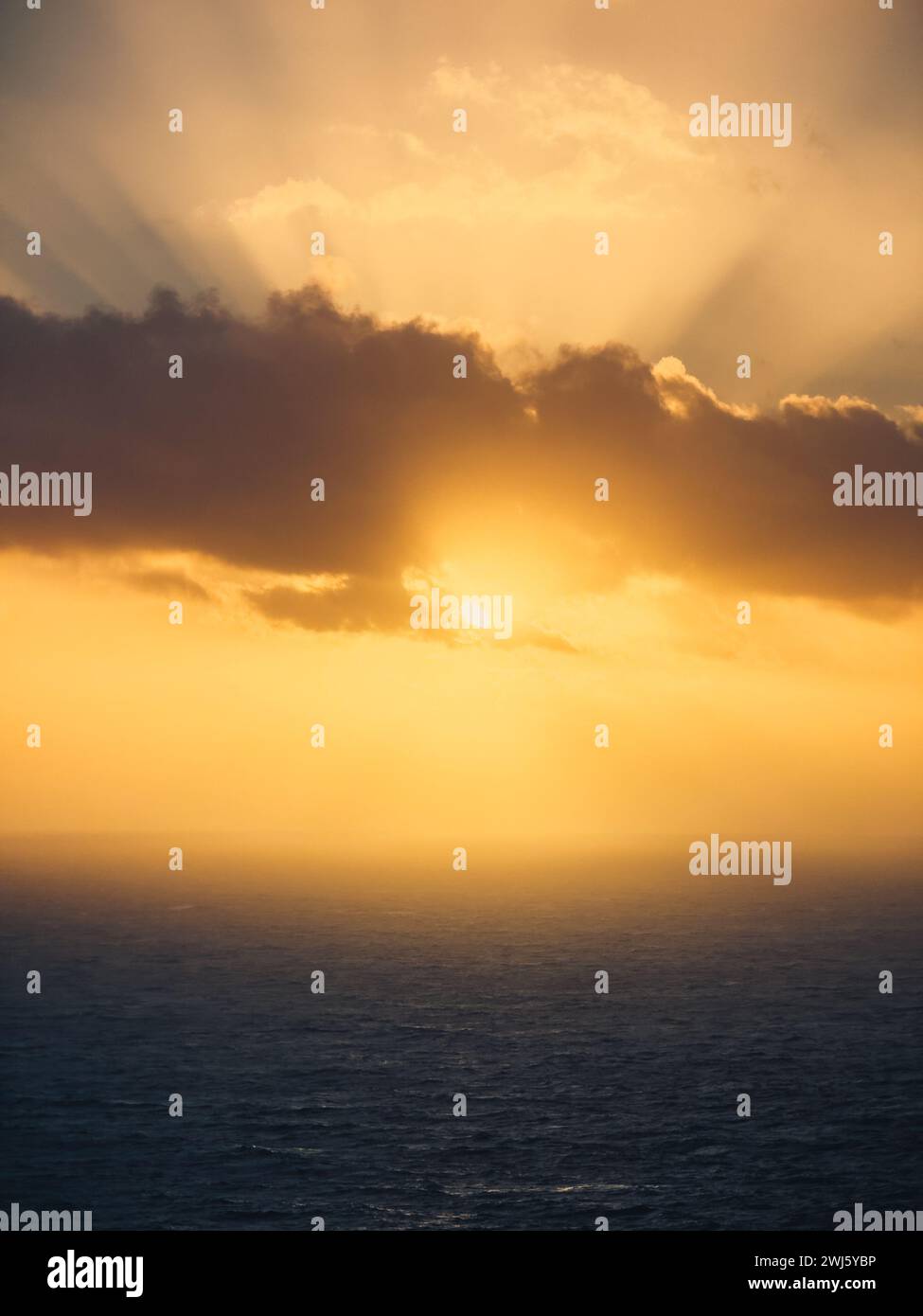 Orange Sunset into the clouds Stock Photo