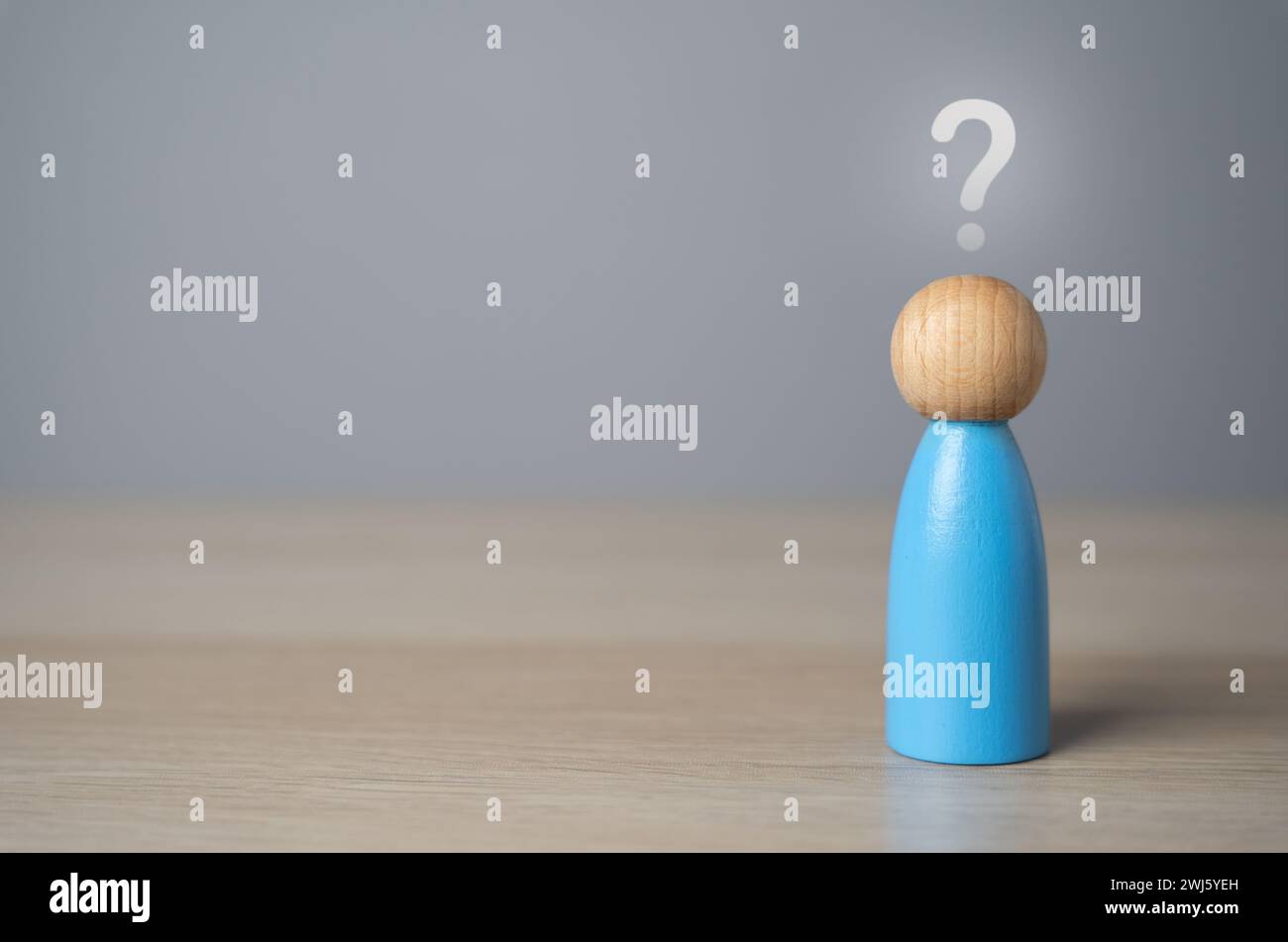 Man figurine with a question mark above his head. FAQ. Thoughts, reasoning and dreams. Introspection, asking yourself questions. Make plans and life g Stock Photo