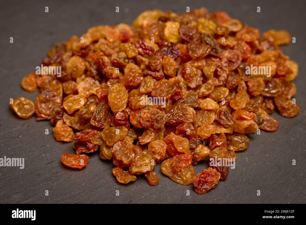 pile of brown raisins on a stone counter Stock Photo - Alamy