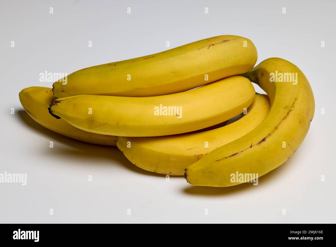 Well-ripened organic bananas on a counter. Stock Photo