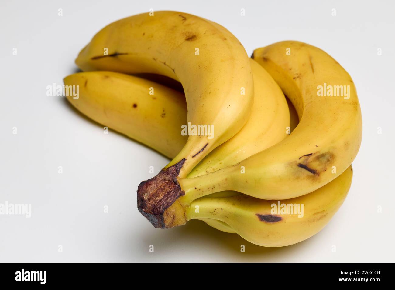 Well-ripened organic bananas on a counter. Stock Photo