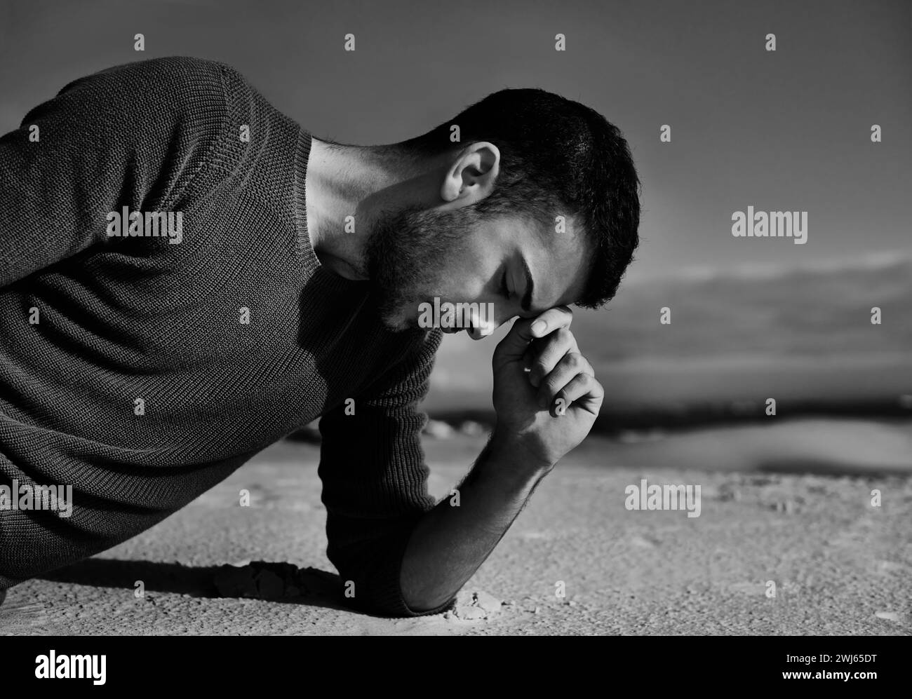 Depression, sad or man in the desert thinking of travel in summer to relax on holiday vacation. Upset, black and white with face of male person on the Stock Photo