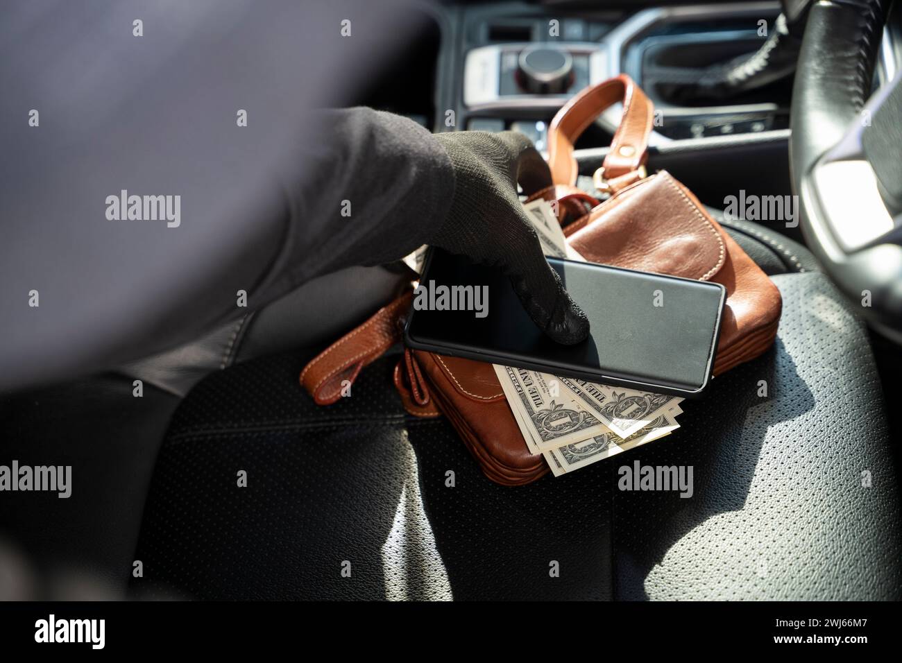 Thieves steal wallet and phone from car seat. Stock Photo