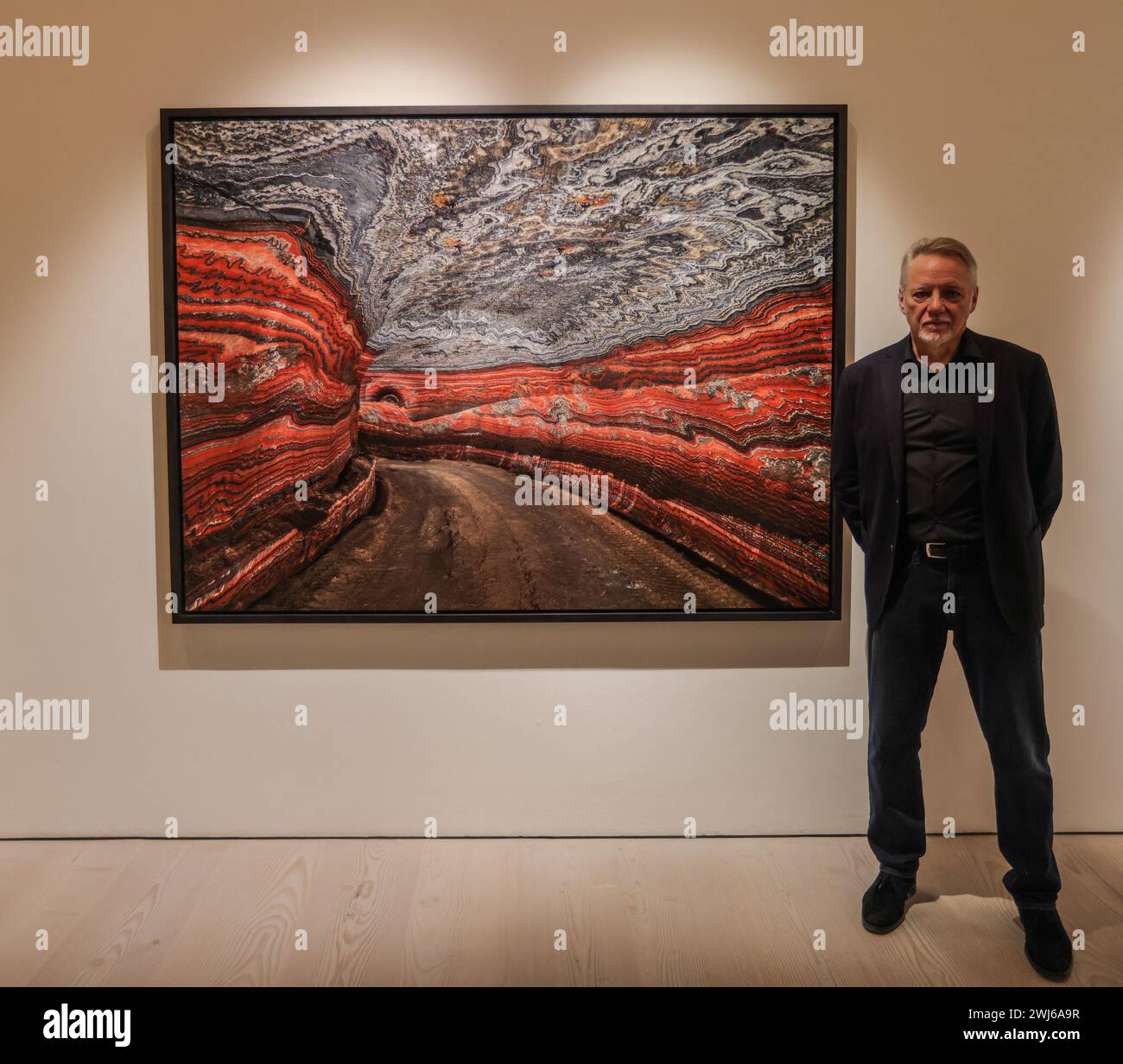 London, UK. 13th Feb, 2024. Edward Burtynsky (pictured) next to Uralkali Potash Mine # 2, Berezniki, Russia 2017.This exhibition marks the largest exhibition ever mounted in the 40  year career of world-renowned photographic artist, Edward Burtynsky, who has dedicated his practice to bearing witness to the impact of human industry on the planet.Paul Quezada-Neiman/Alamy Live News Credit: Paul Quezada-Neiman/Alamy Live News Stock Photo