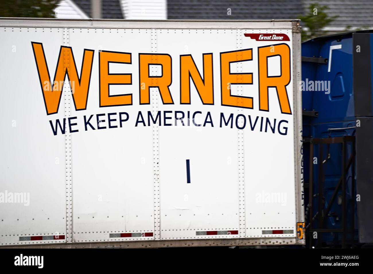 New York, NY - October 27, 2023: Werner Enterprises, Inc. American logistics trucking company logo closeup on highway cargo truck. Stock Photo