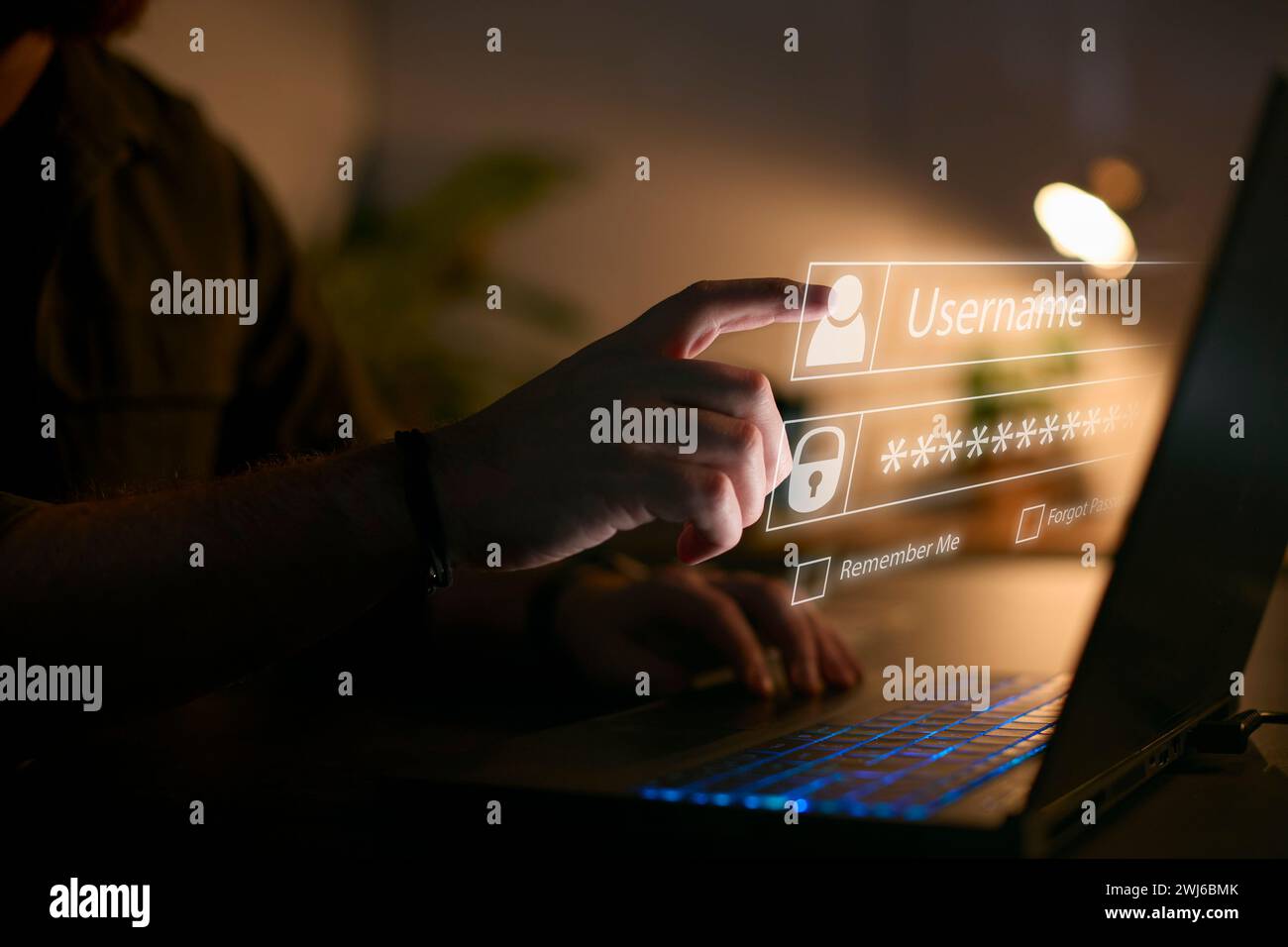 Computer Security Concept With Online Log In Credential Projected Onto Screen Of Person Using Laptop Stock Photo