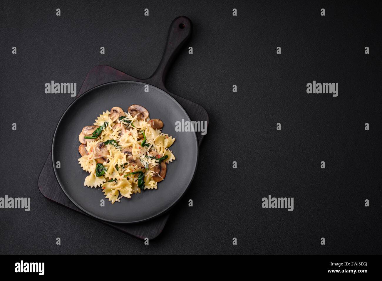 Delicious farfalle pasta with mushrooms, cheese and spinach with spices