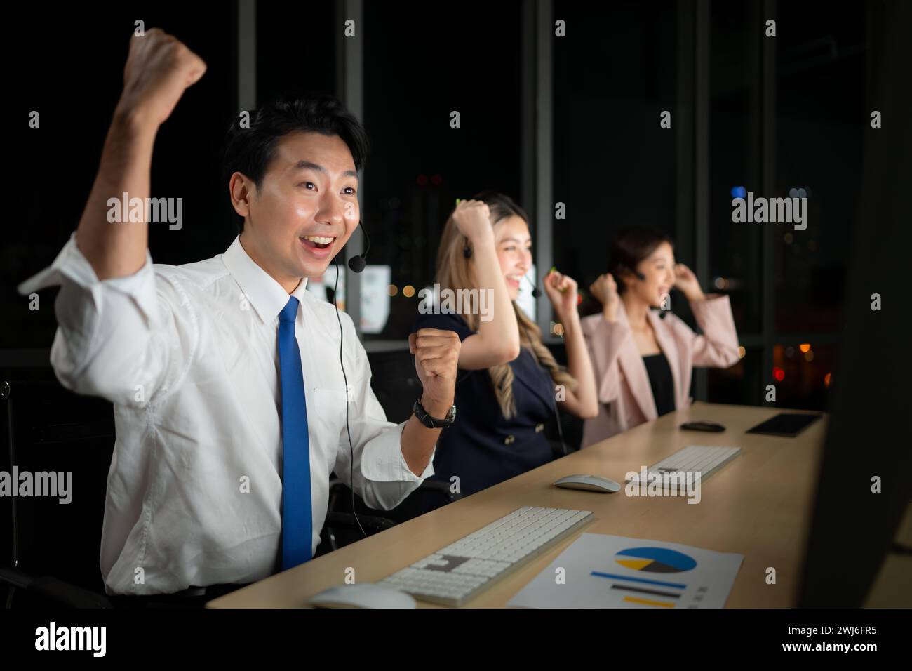 Successful asian business people celebrating success in office at night, International financial investment company concept Stock Photo