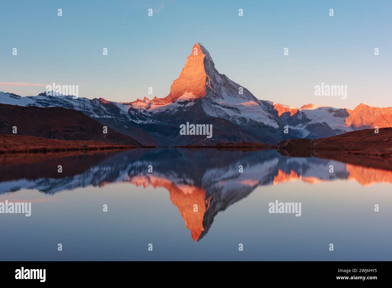 Colorful sunrise on Stellisee lake. Snowy Matterhorn peak with red ...