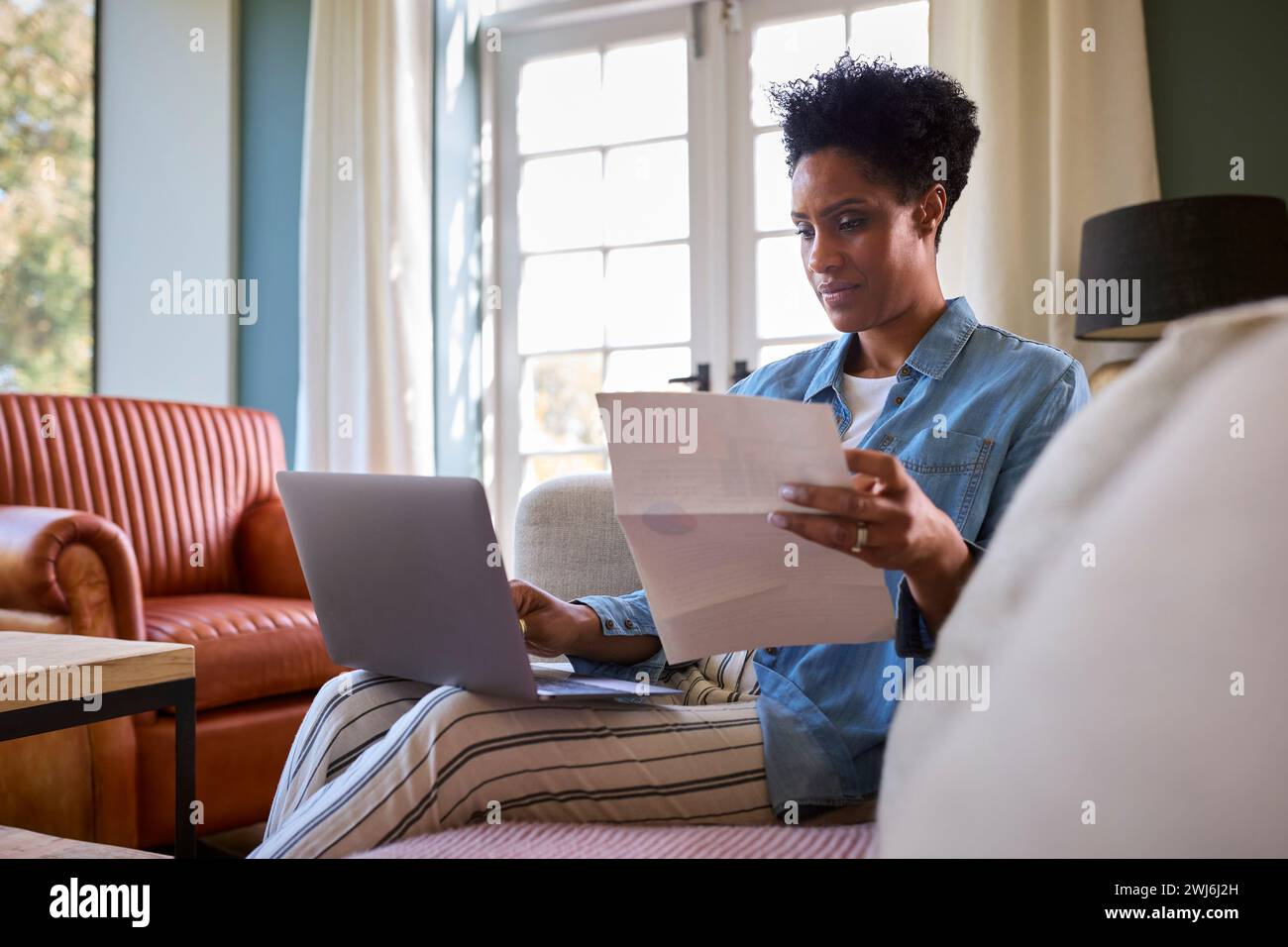 Mature black woman worried home hi-res stock photography and images - Alamy